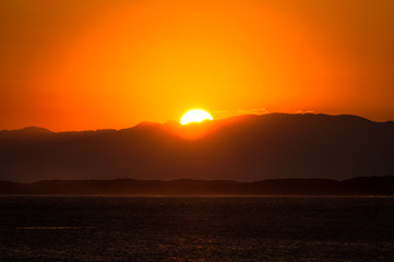 Sun Setting Over Hills