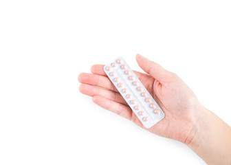 Birth control pills or pregnancy prevention pills of full package in female or woman right hand isolated on white background with copy space for text insertion or decoration (clipping path included)