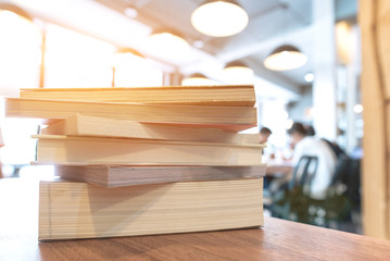 books stack on the library table. At the time of university student exams in selective focus.
