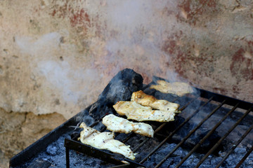 Chicken breasts on a grill. 
