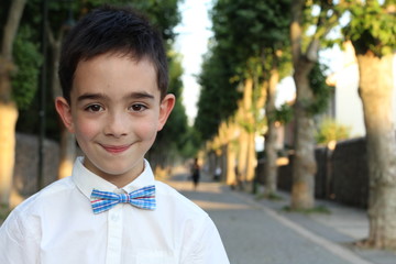 Friendly little boy wearing bow tie isolated 