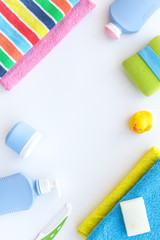 Bathroom set. Towels, bottles with soap and shampoo on white backgrond top view copyspace