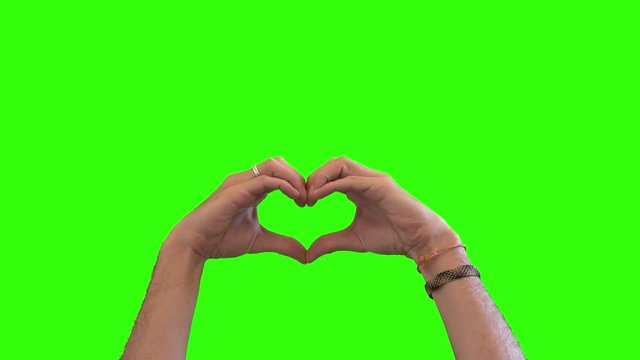 Romantic Love Sign With Hands On Green Screen. Hands making a love sign over a green screen background