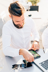 Fototapeta na wymiar young businessman bearded outdoor using tablet - remote working, technology, communication concept