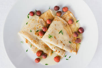 dessert pancakes with garden berries and herbs