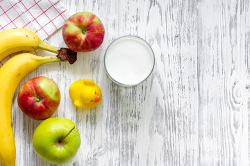 Kids breakfast with fruits on light wooden table background top view copyspace