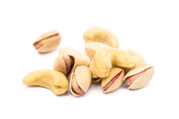 Pile of roasted pistachios and cashew  isolated on white background 