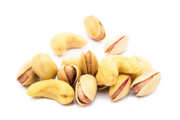 Pile of roasted pistachios and cashew  isolated on white background 