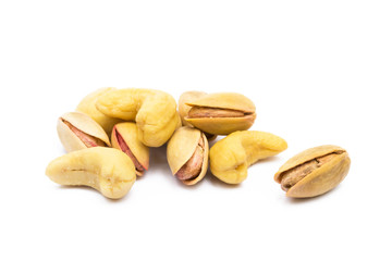 Pile of roasted pistachios and cashew  isolated on white background 
