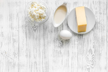 Natural food. Milk, cottage, cheese and eggs on light wooden background top view copyspace