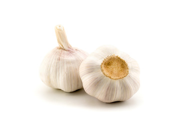 Two heads of garlic on a white