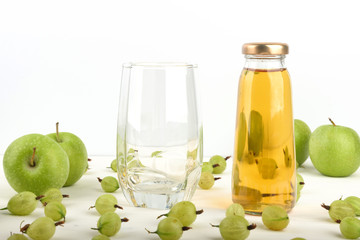 Apple juice in a glass bottle. Detox green Apple and gooseberry juice in a glass, healthy drinks concept