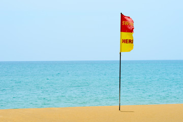 Warning flag forbid swimming in the sea. Embroidered on the beach