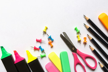 School accessories marker, pencil, scissors, eraser, paper clips, paper on a light background with copy space. Concept back to school