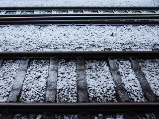 snow and frost on railway tracks in winter running in parallel lines