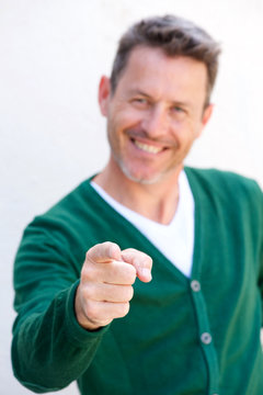 Close Up Happy Older Man Pointing Finger On White Background