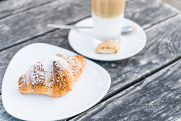 coffee cup latte  and fresh baked croissants on wooden background with copy space