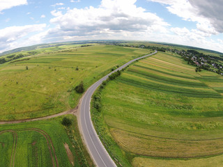 Fototapeta premium Aerial view of the sown fields near the motorway