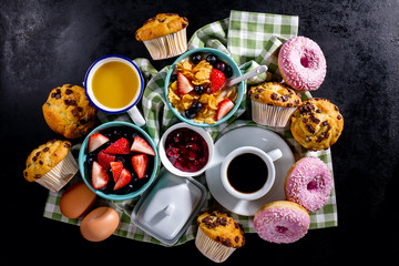 Tasty fresh breakfast food ingredients on black dark background. Ready to cook. Home Healthy Food Cooking Concept.