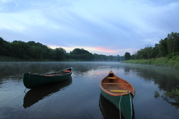 canoe on river in canada sunrise
