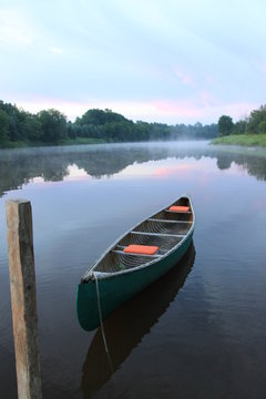 canoe on river at sunrise, canada © charline