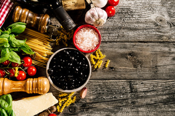 Tasty fresh appetizing italian food ingredients on old rustic wooden background. Ready to cook....