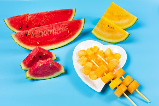 Yellow and red watermelon slices in different shapes
