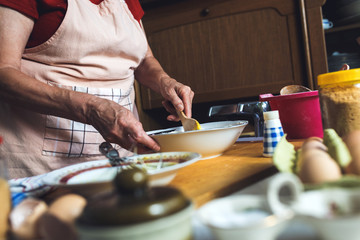 Close up of female baker hands kneading dough.