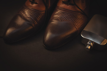 Men shoes and perfume on black background