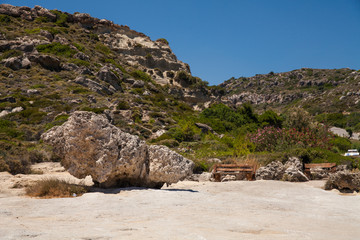 Fototapeta na wymiar Bench on the beach on the Rhodesian island of Rhodes.