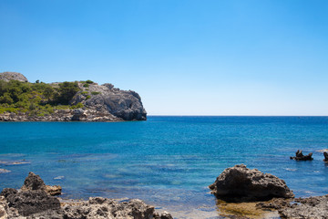 Beach off the coast of the island of Rhodes in Greece. Seaside landscape. Rocky coast and sea.