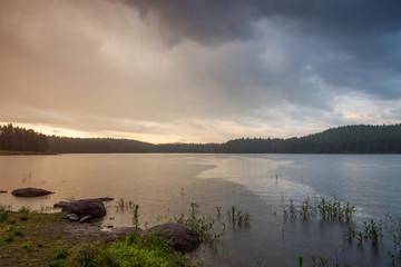 Rain over the lake at sunset
