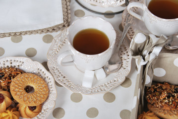 Tasty fresh buns with granny's tea in a retro cup