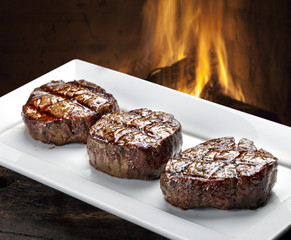 Three steaks roasted on the grill