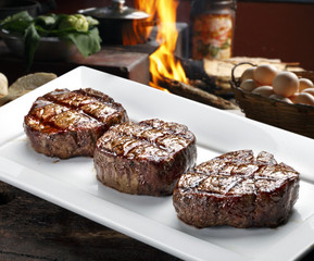 Three steaks roasted on the grill