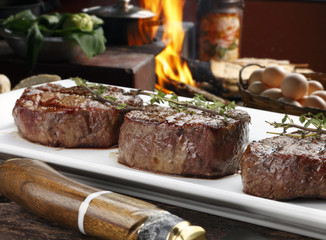 Three steaks roasted on the grill