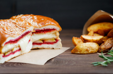 Burger with Camembert cheese and cowberry sauce