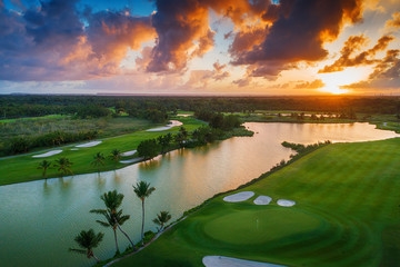 Aerial view of tropical golf course at sunset, Dominican Republic. - obrazy, fototapety, plakaty
