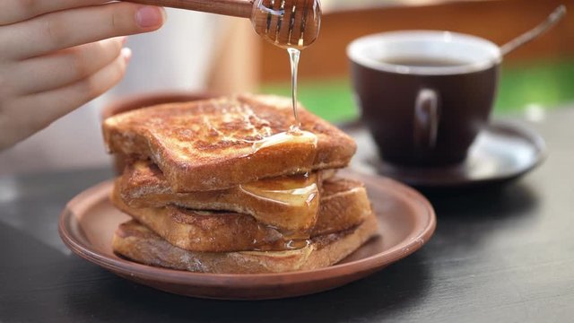 Cinemagraph -French toasts with honey. Healthy breakfast. Motion Photo.