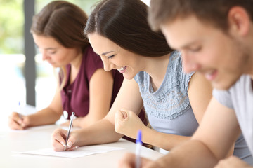 Excited student during an exam at classroom