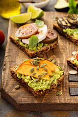Variety of avocado toasts on a cutting board