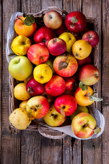 Fresh apples in a basket on an old wooden background.Food or Healthy diet concept.Super Food.Vegetarian.selective focus.Vintage style.