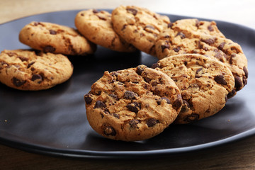 Chocolate cookies on wooden table. Chocolate chip cookies shot