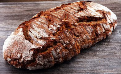 freshly baked bread on wooden board. cutted bread