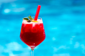 Cold red cocktail near the swimming pool