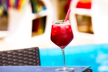 Cold red cocktail near the swimming pool