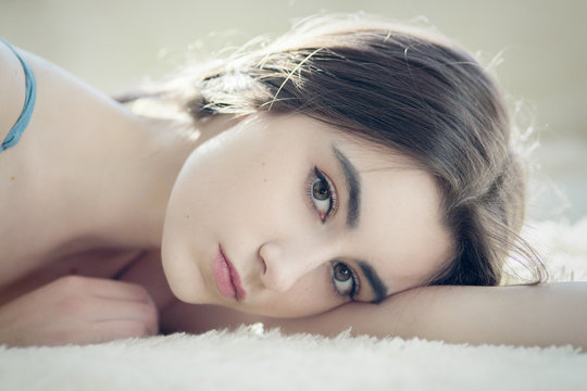 sensual girl lying looking at camera, toned image