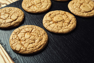 Biscuit sweet cookie background. Domestic stacked butter biscuit pattern concept,close up macro.Homemade cookies on wooden table.Cereal biscuits with the sesame,peanuts,sunflower and amaranth.