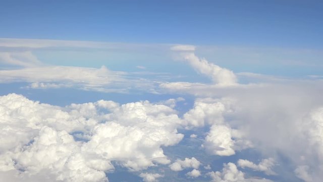 High quality aerial shot above the clouds of mountains in 4K