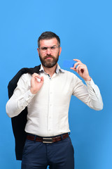 Guy with serious face and glasses isolated on blue background